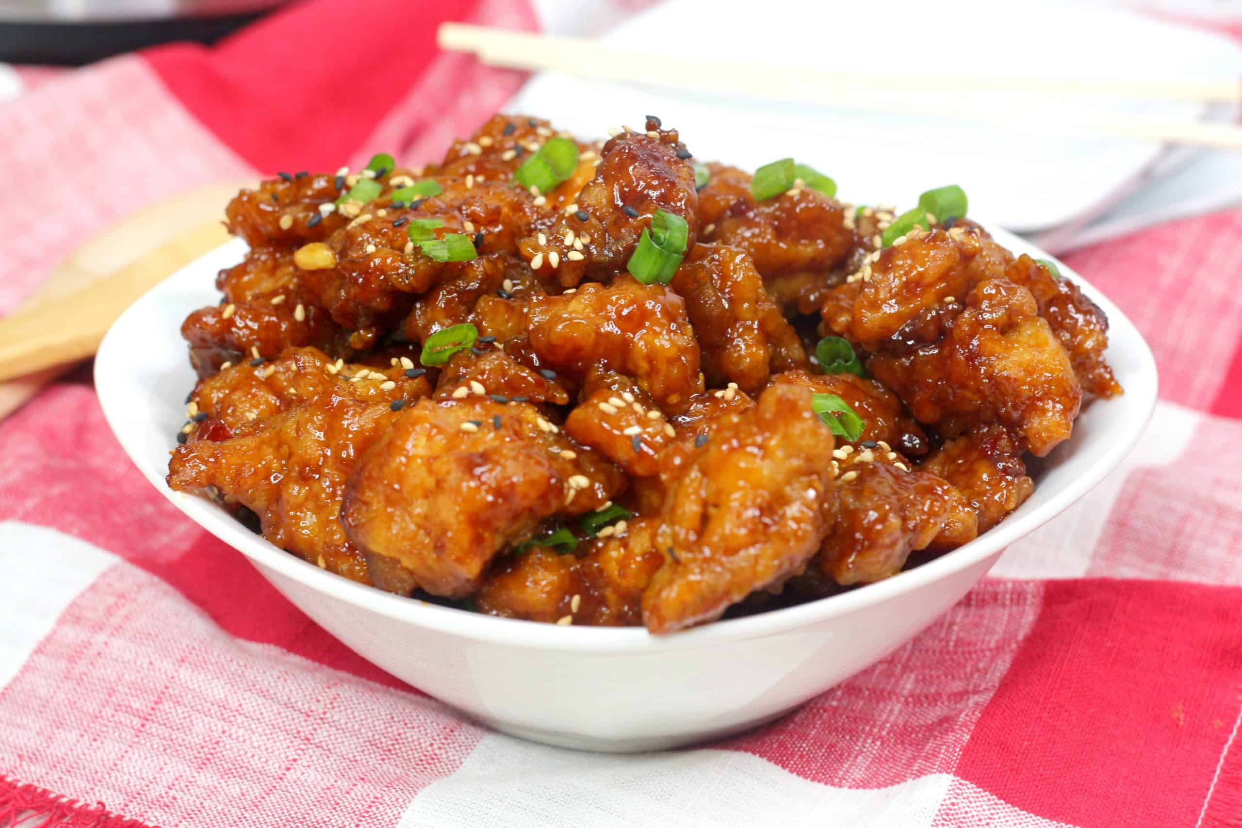 Bowl of general tso chicken on tablecloth