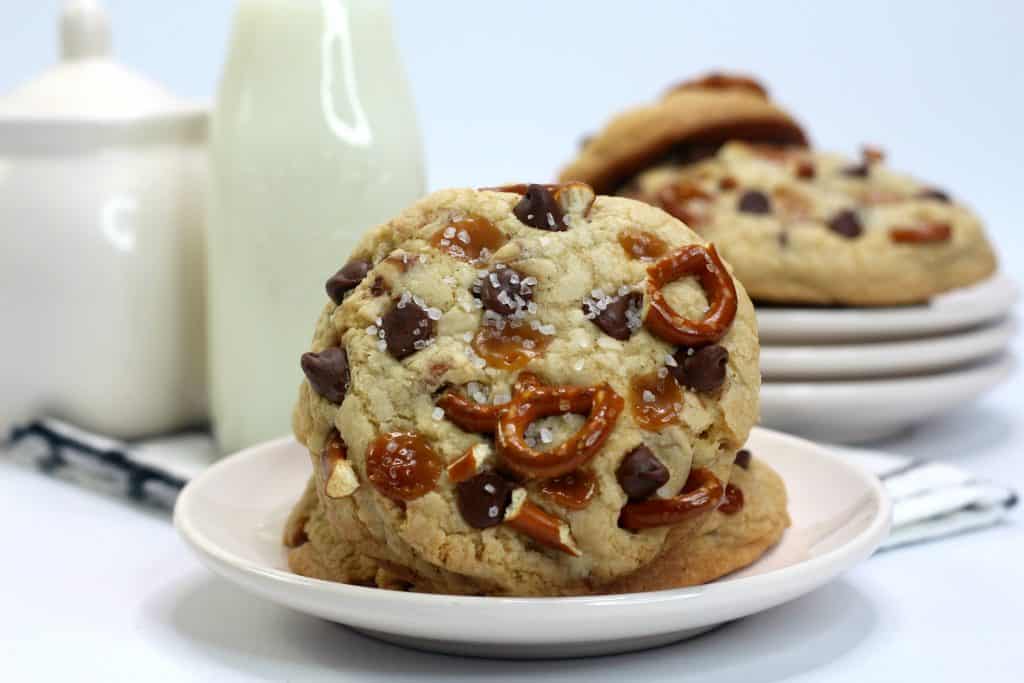 Sweet and Salty Kitchen Sink Cookies on a plate with milk