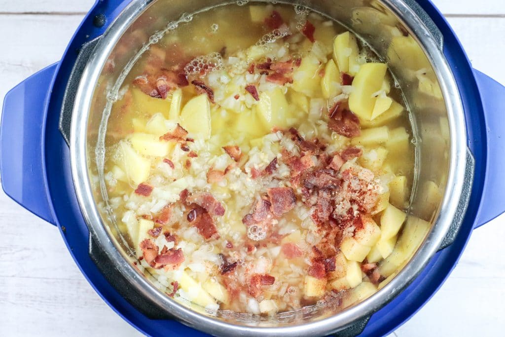 potatoes, broth and bacon in pot