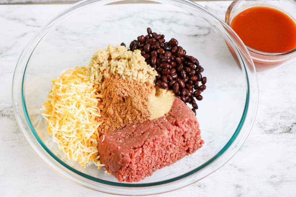 beef, cheese, beans, and taco seasoning in bowl