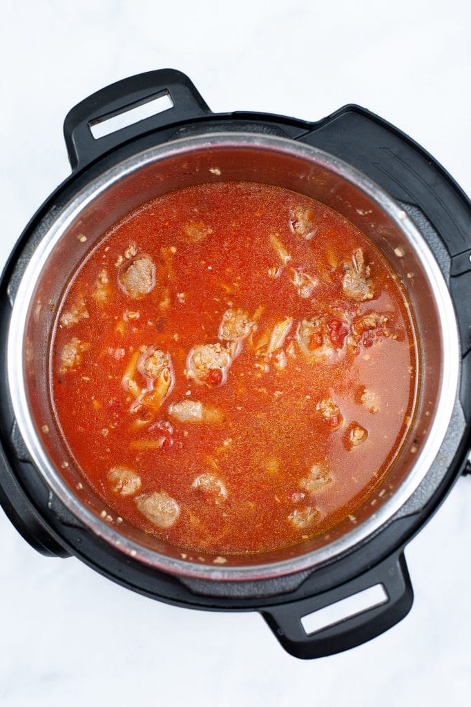 Sauce, Uncooked pasta, and italian sauce in pot.