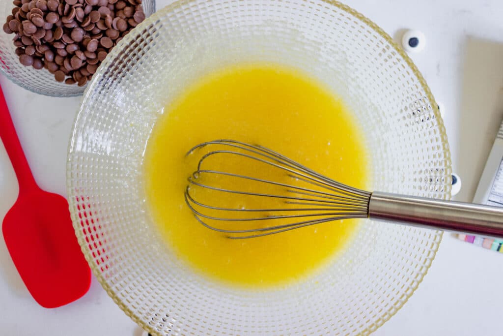 eggs and oil mixed together in bowl with whisk