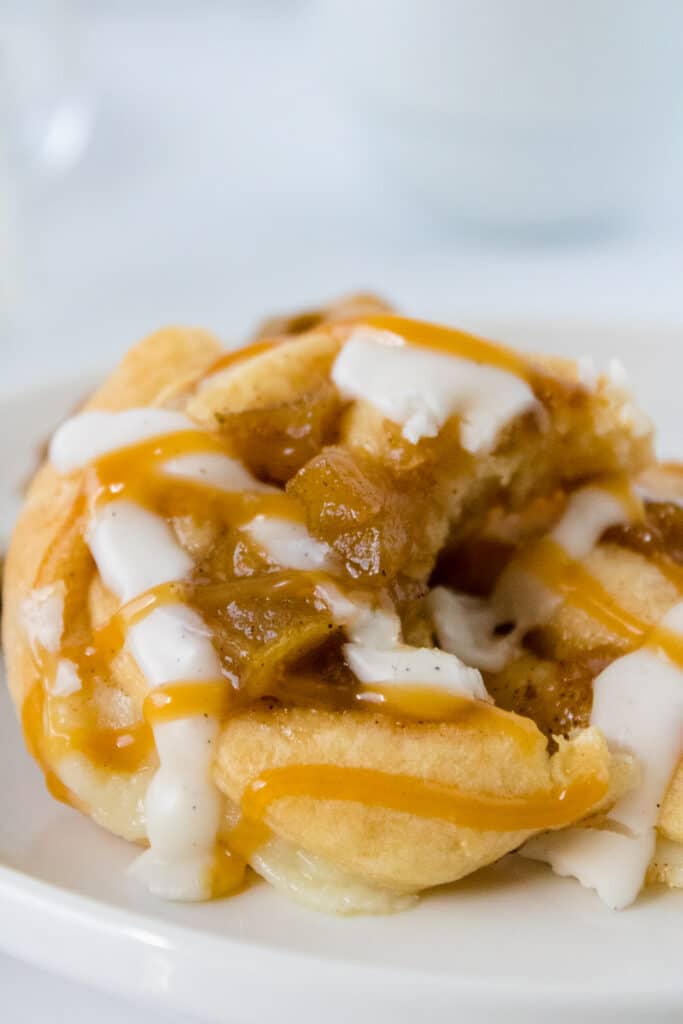close up image of a caramel apple danish on a white plate