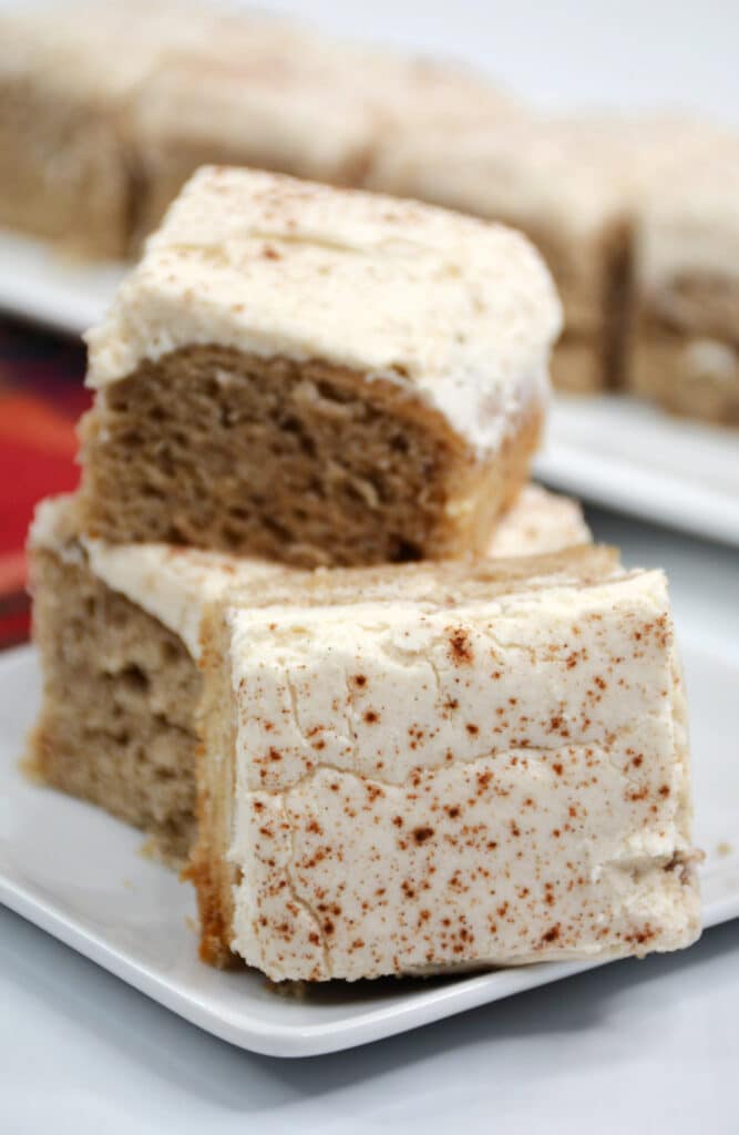 zoomed in side view image of three banana bars on a white saucer