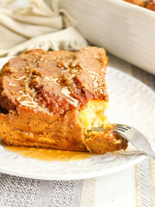vertical image of a slice of Pumpkin French Toast Casserole on a white plate