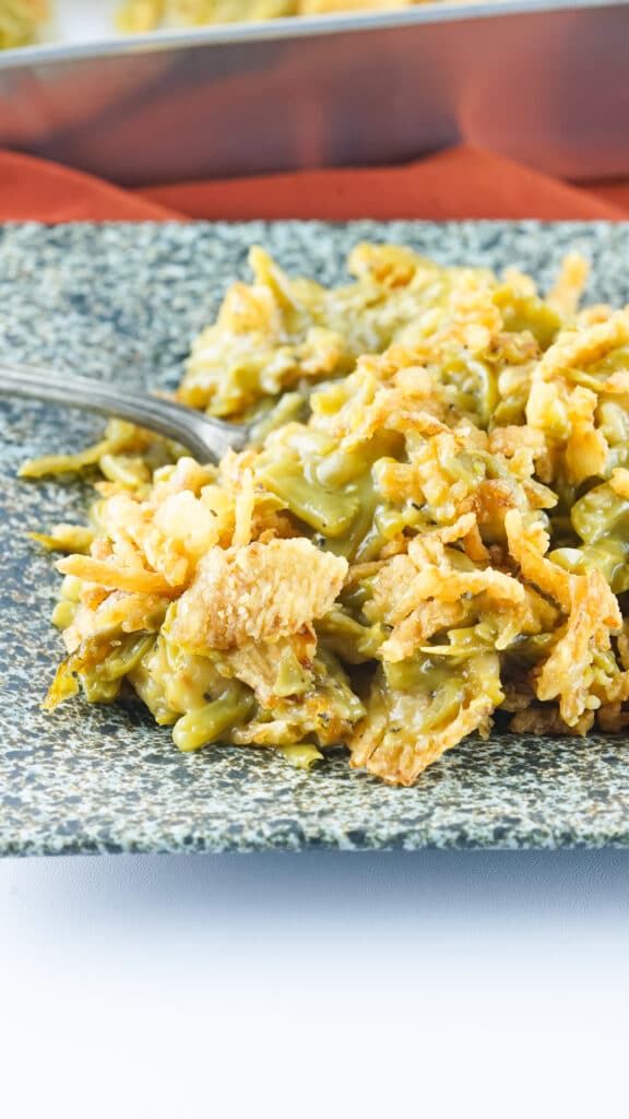 Close up image of Smoked Green Bean Casserole on a black and white marble plate