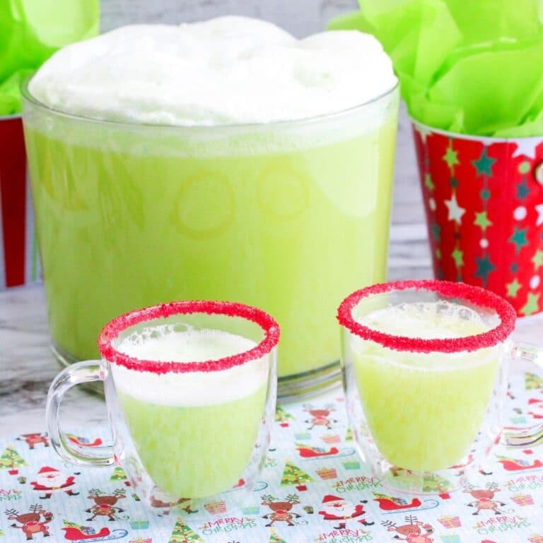 Square final image of one punch bowl and two glass mugs full of grinch punch