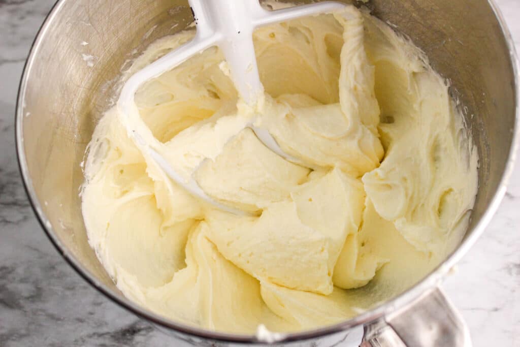 butter and sugar in a mixing bowl being creamed
