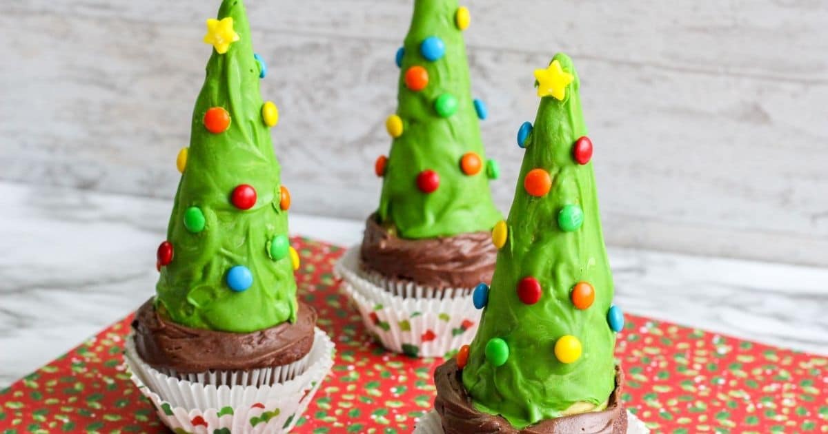 Rectaingle image of Christmas Tree Cupcakes on a red napkins