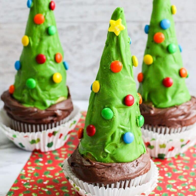 close up zoomed image of three Christmas tree cupcakes