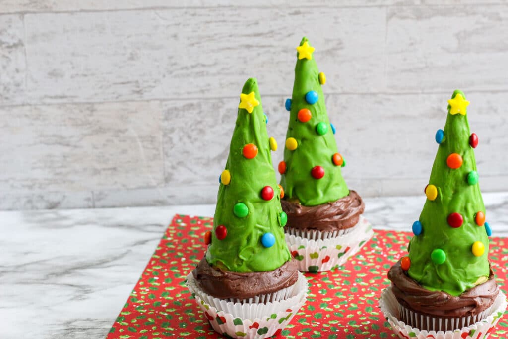 off center image of three Christmas tree cupcakes.