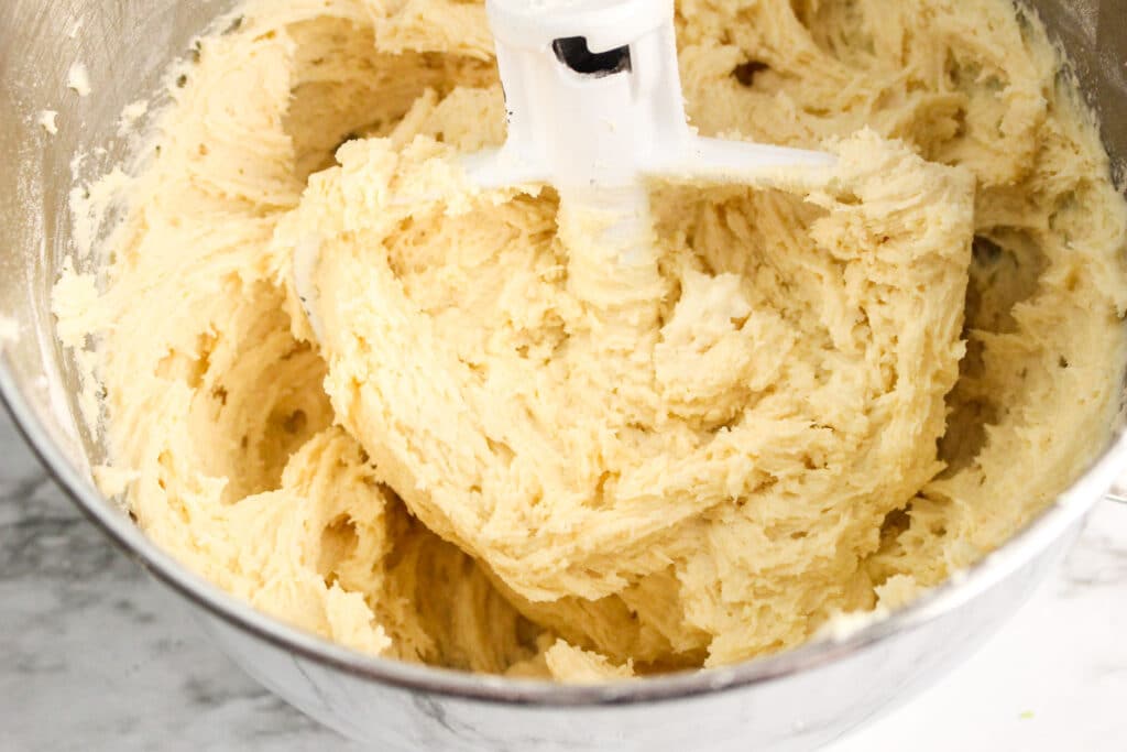 cookie dough in a stand mix with stainless steel mixing bowl