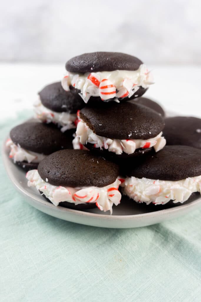 Peppermint Whoopie PIes stacked on a light gray plate in a pyramid