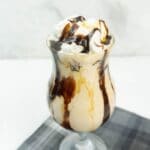 Square image of a peanut butter whiskey shake in a glass