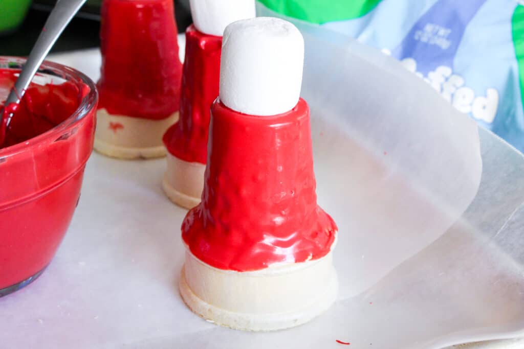 marshmallow on top of a red ice cream cone