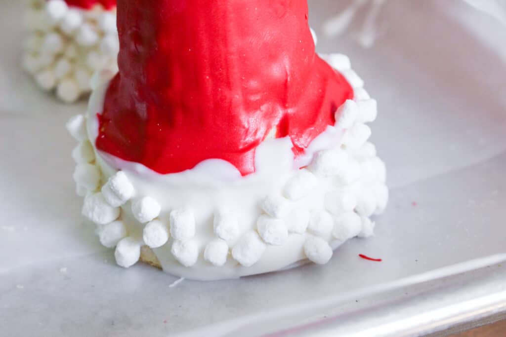 red and white ice cream cone dipped in marshmallow bits