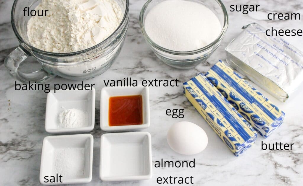 ingredients for star cookies laid out on a marble table
