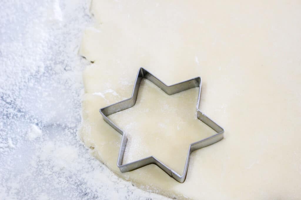 cream cheese cookie dough rolled out with a star cookie cutter on top