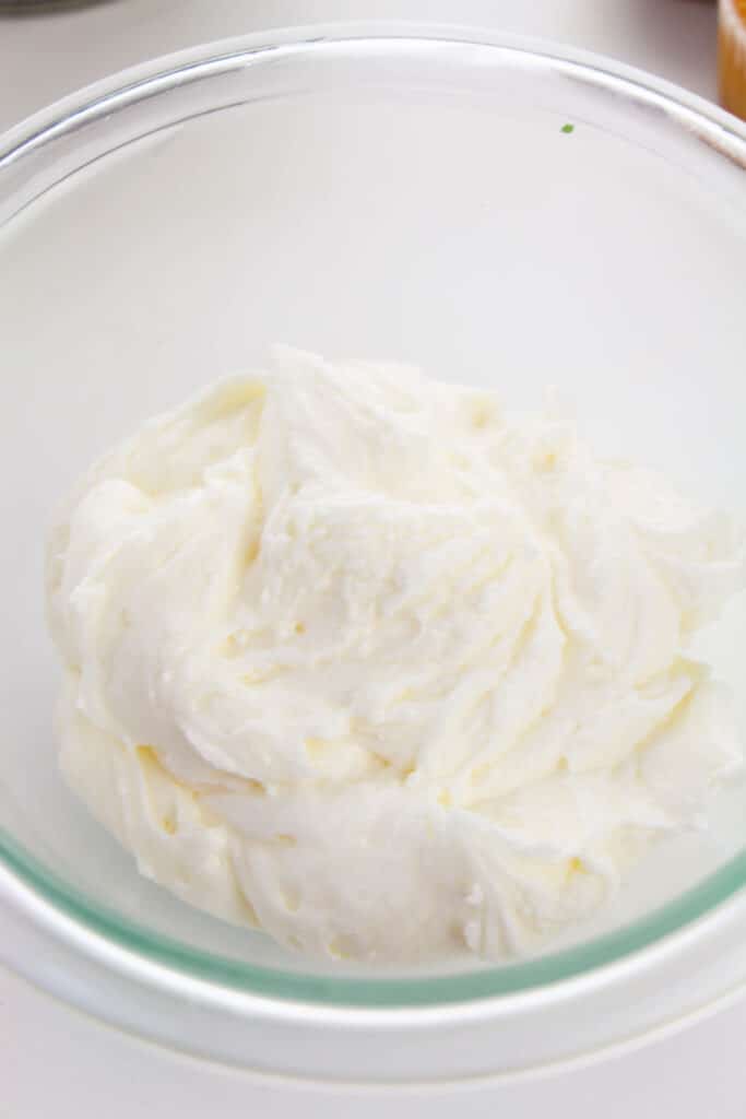 cream chees frosting in a glass mixing bowl