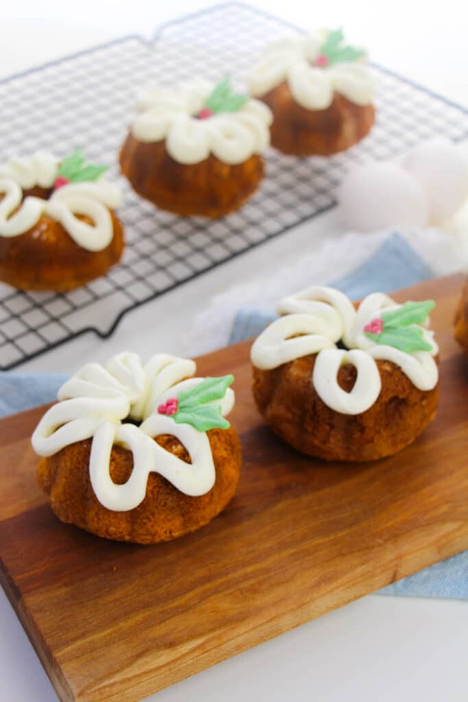 five minute christmas bundt cakes on a wooden cutting board and cooling rack