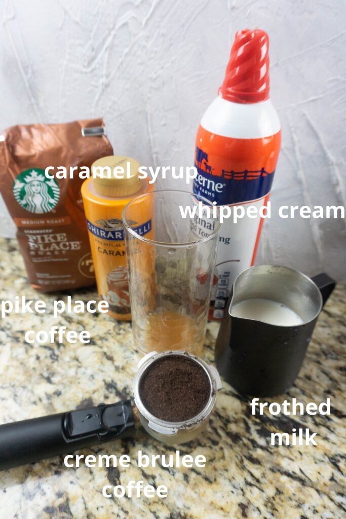 ingredients for caramel brulee latte on a marble counter