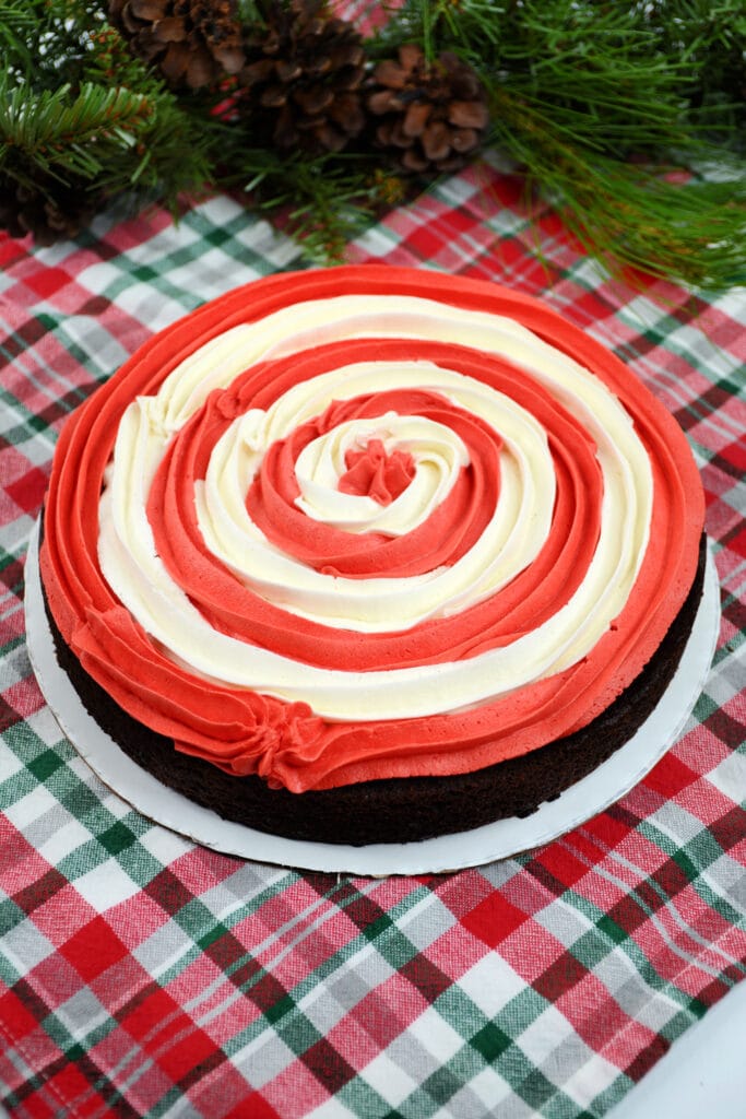 chocolate cake layer piped with red and white frosting
