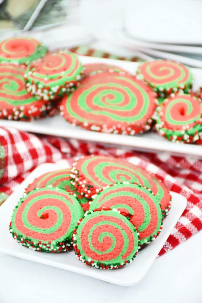 side view image of a plate and platter with christmas pinwheel cookies