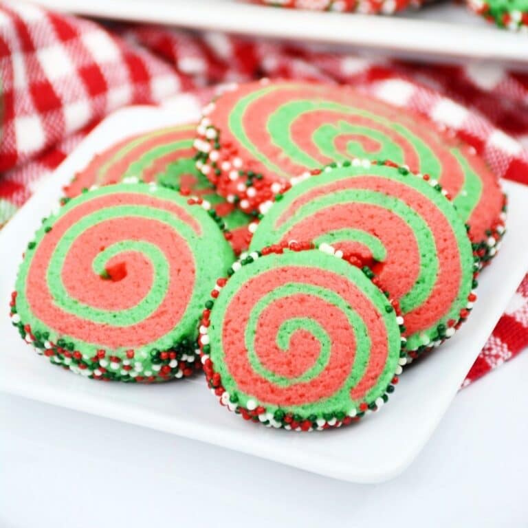 Square image of a close up plate of Christmas Pinwheel cookies