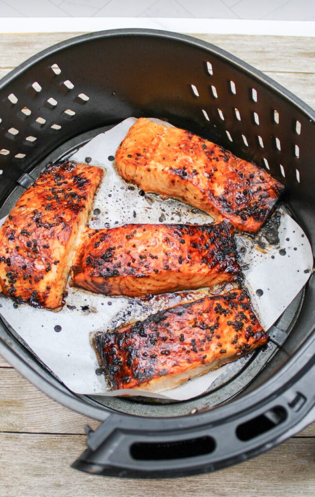 cooked salmon in an air fryer basket