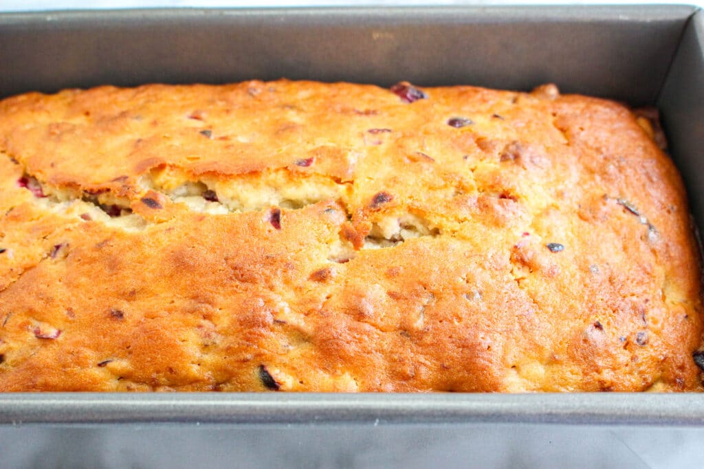 cranberry banana bread in a greased loaf pan