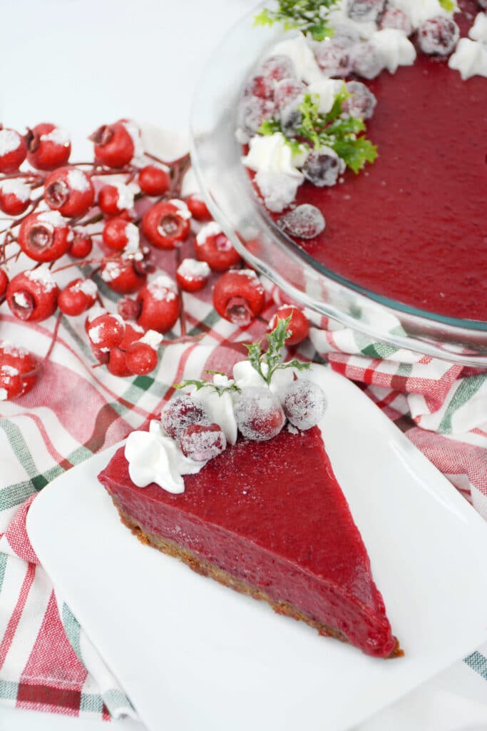 vertical image of a slice of cranberry curd tart