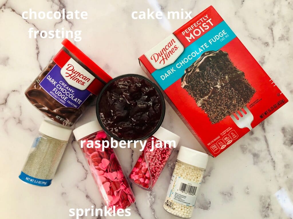 ingredients for Dark Chocolate Raspberry Cupcakes on a marble countertop