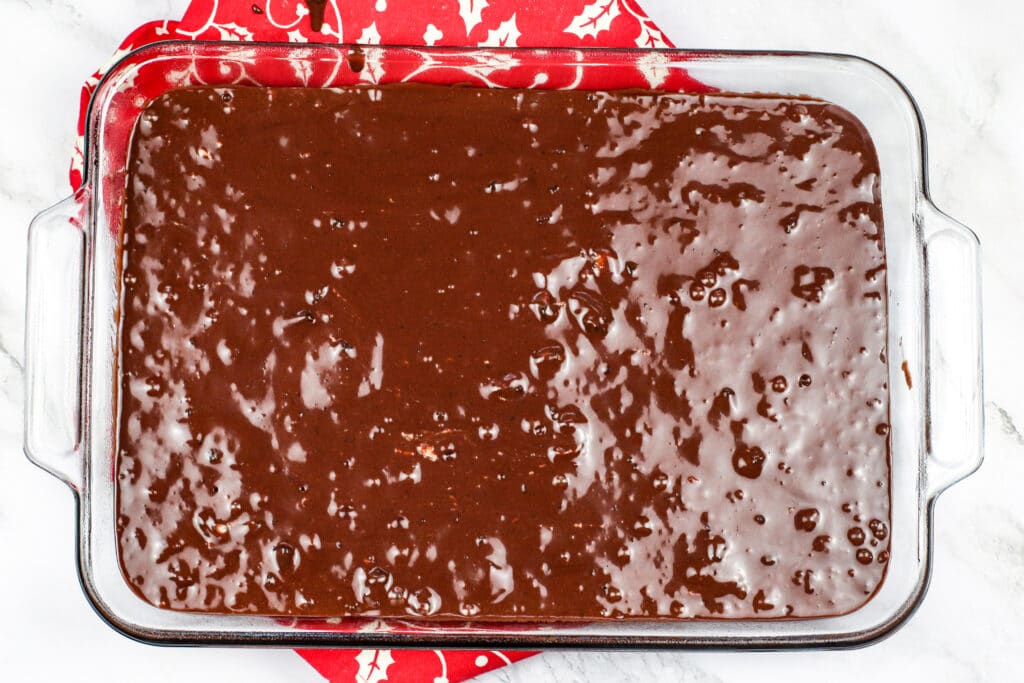 unbaked brownies in a glass baking pan