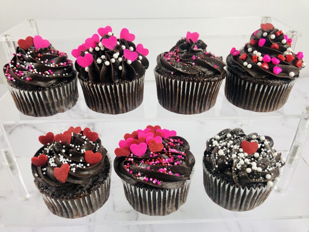 Dark Chocolate Raspberry Cupcakes on a clear glass cupcake stand