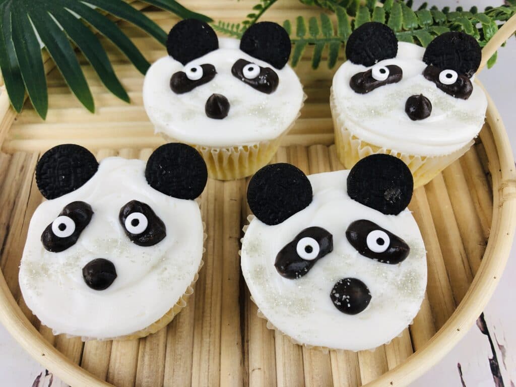 finished panda cupcakes on a bamboo serving tray
