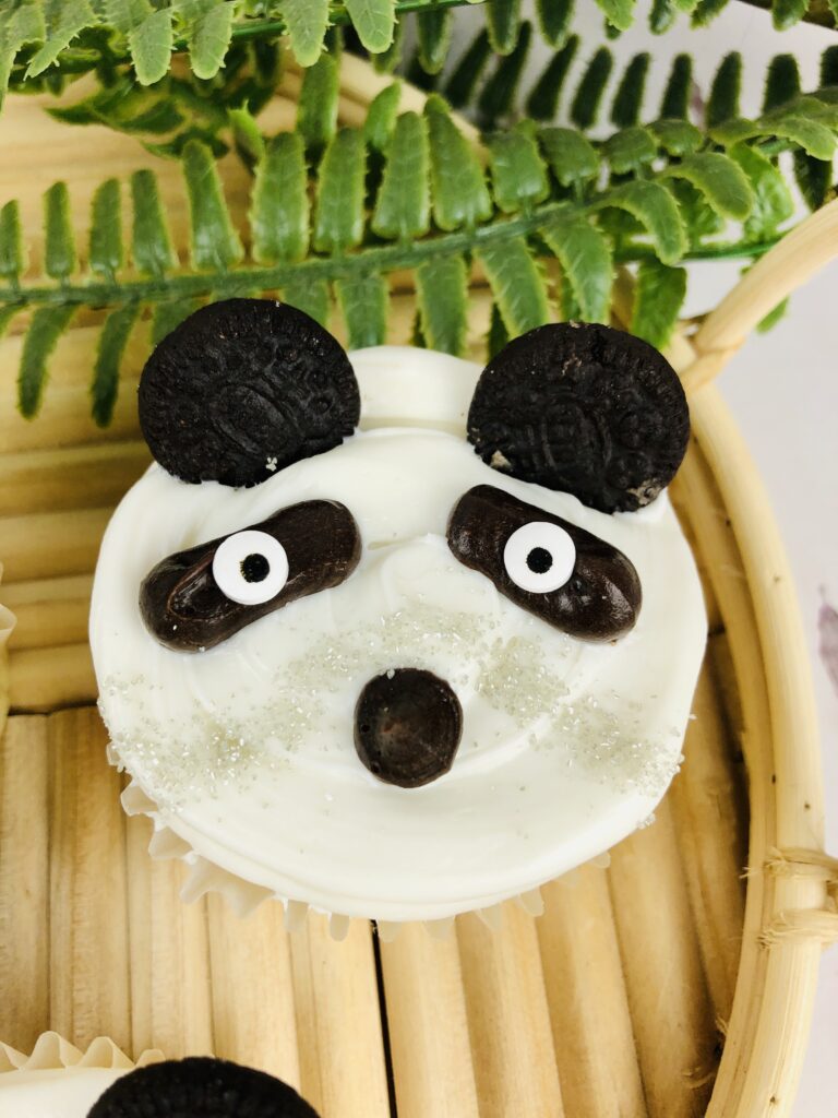 single panda cupcake on a bamboo serving tray