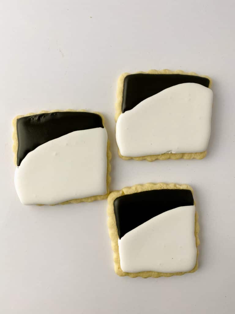 sugar cookies topped with black and white royal icing