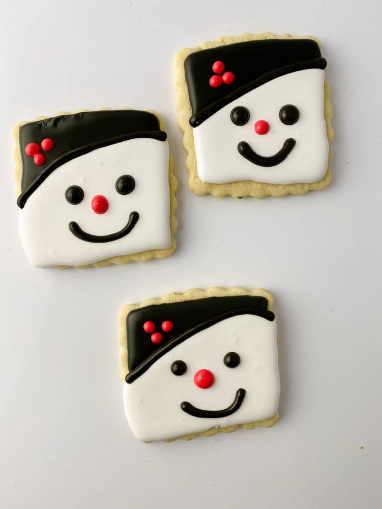 Snowman cookies decorated with royal icing