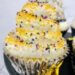 close up square image of a new years cupcakes with gold sprinkles