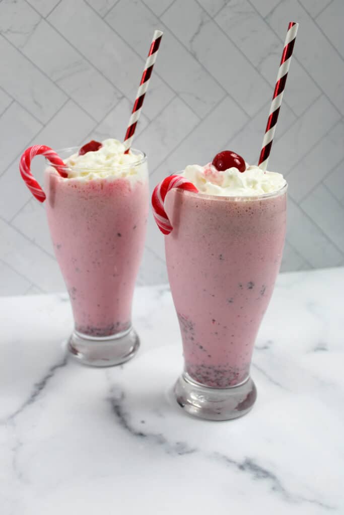 two finished copycat chickfila peppermint milkshakes on a marble counter