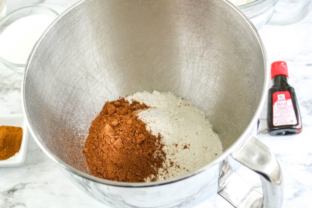 flour and cinnamon in a sliver mixing bowl
