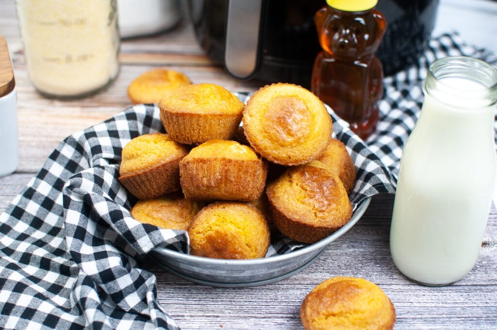 Air Fryer Cornbread Muffins in a platter with a black and white napkin