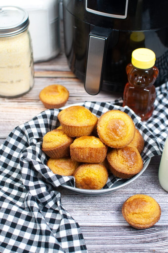 air fryer cornbread muffins stacked in a stainless steel platter