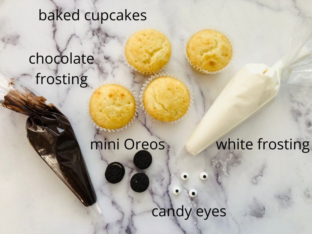 ingredients for panda cupcakes on a marble countertop.