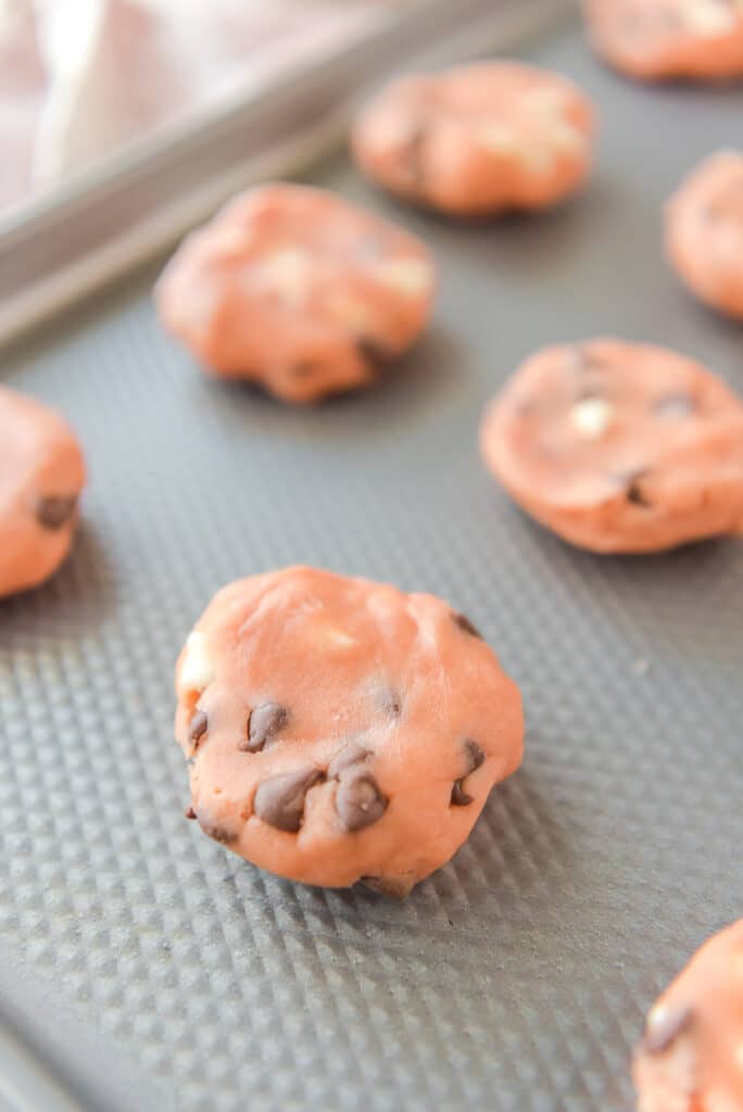 dough shaped into balls on a metal baking sheet