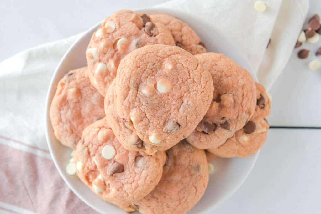 birds eye image of pink chocolate chip cookies on a white plate