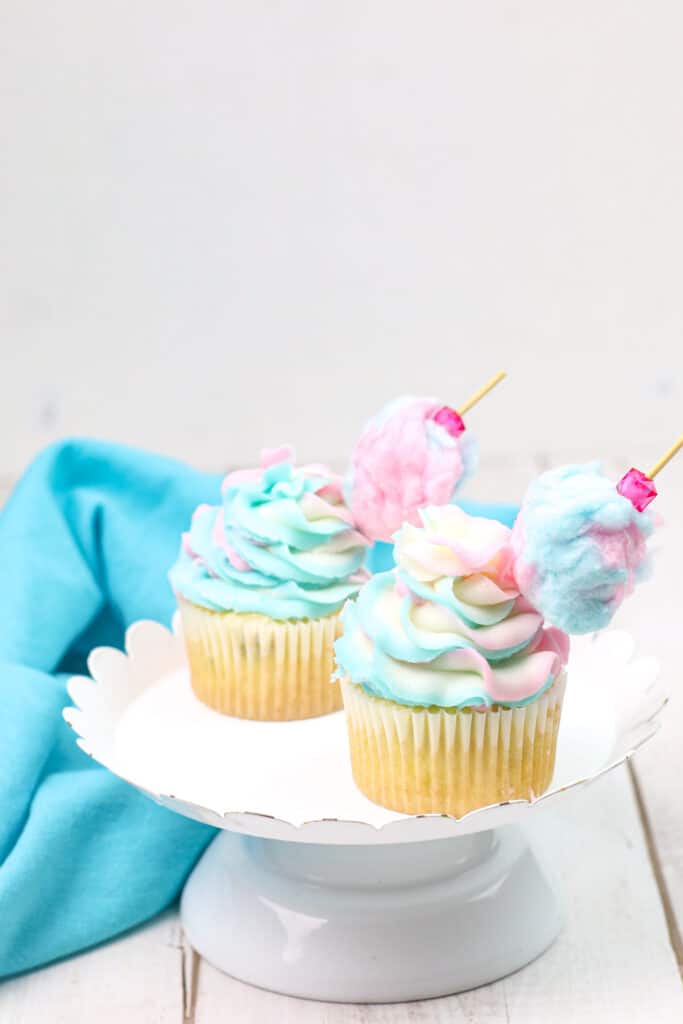 Blue and Pink Cotton Candy Cupcakes on a white cake stand