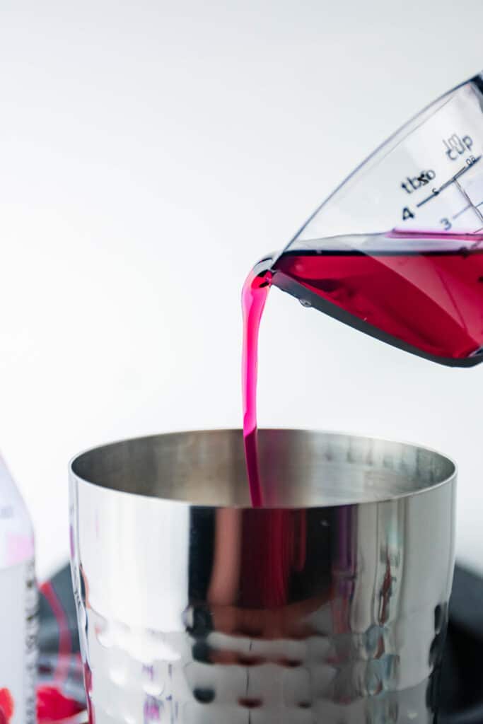 cupid's cocktail being poured into a shaker