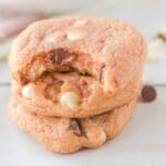 square image of three pink chocolate chip cookies with the top one has bite misisng