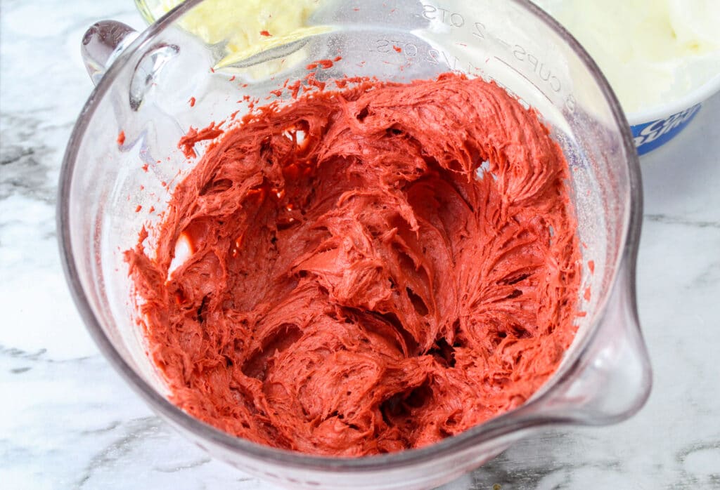 cream cheese and red velvet cake mix in a glass mixing bowl